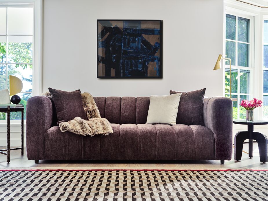 Find the Darcy Performance Velvet Sofa here and the Turner Faux-Fur Throw here. Find the rug here, the side table on the right here, and the other side table here. 
