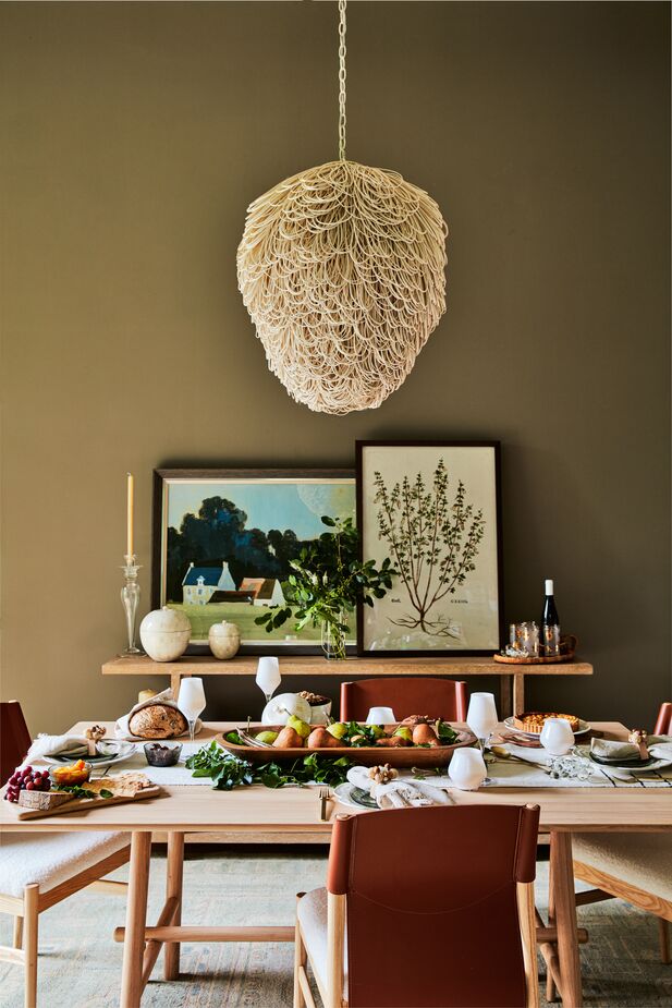 Rattan can be used for much more than furniture. Case in point: the Finley Chandelier, a confection of unbleached rattan loops. The faux-shearling upholstery of the Peyton Dining Chairs leans into the ongoing love of sherpa and bouclé fabrics. Find the dining table here. Photo by Joe Schmelzer. 
