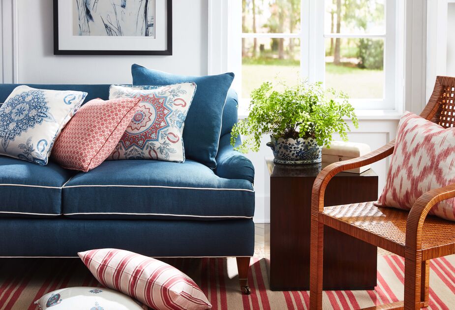 The addition of red almost automatically invigorates blue; orange with blue is even more energizing (and Eclectic), as they’re opposites on the color wheel. Find a similar sofa here and similar ticking-stripe pillows here. 
