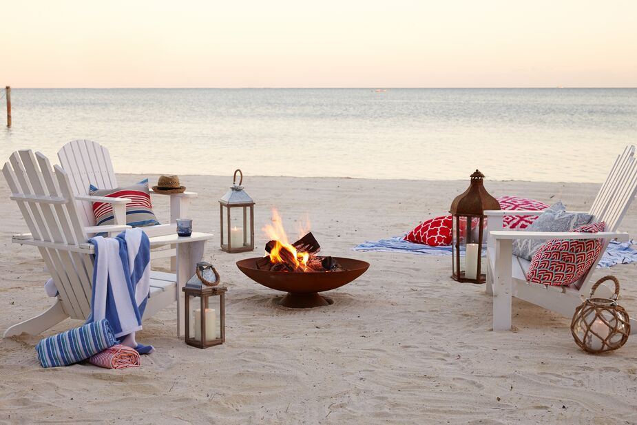 Adirondack chairs are a New England mainstay. Find eco-friendly, weather-resistant white chairs here and the round lantern here.
