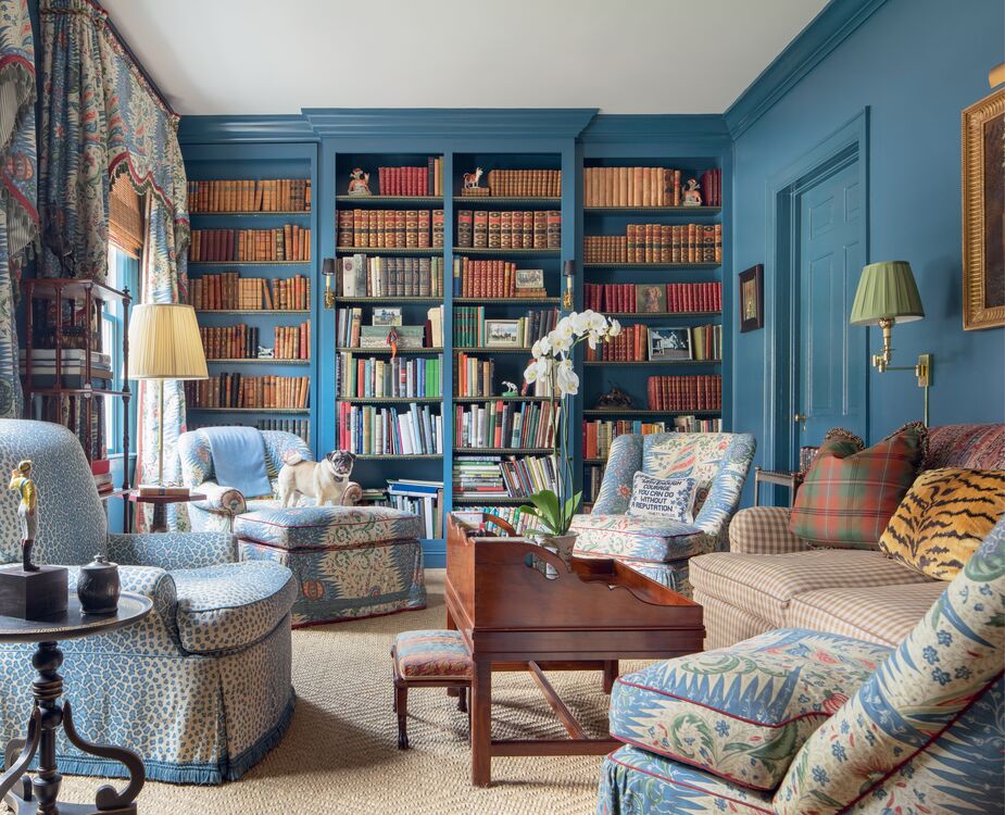 In the library of a South Carolina estate, Buatta layered checks, chintzes, and tchotchkes—along with a needlepoint pillow quoting Gone with the Wind’s Rhett Butler: “With enough courage, you can do without a reputation.” “Mario often included pillows needlepointed with witticisms. Their humor makes a space less formal and more personalized,” writes Emily Evans Eerdmans. Photo: © Scott Frances / OTTO
