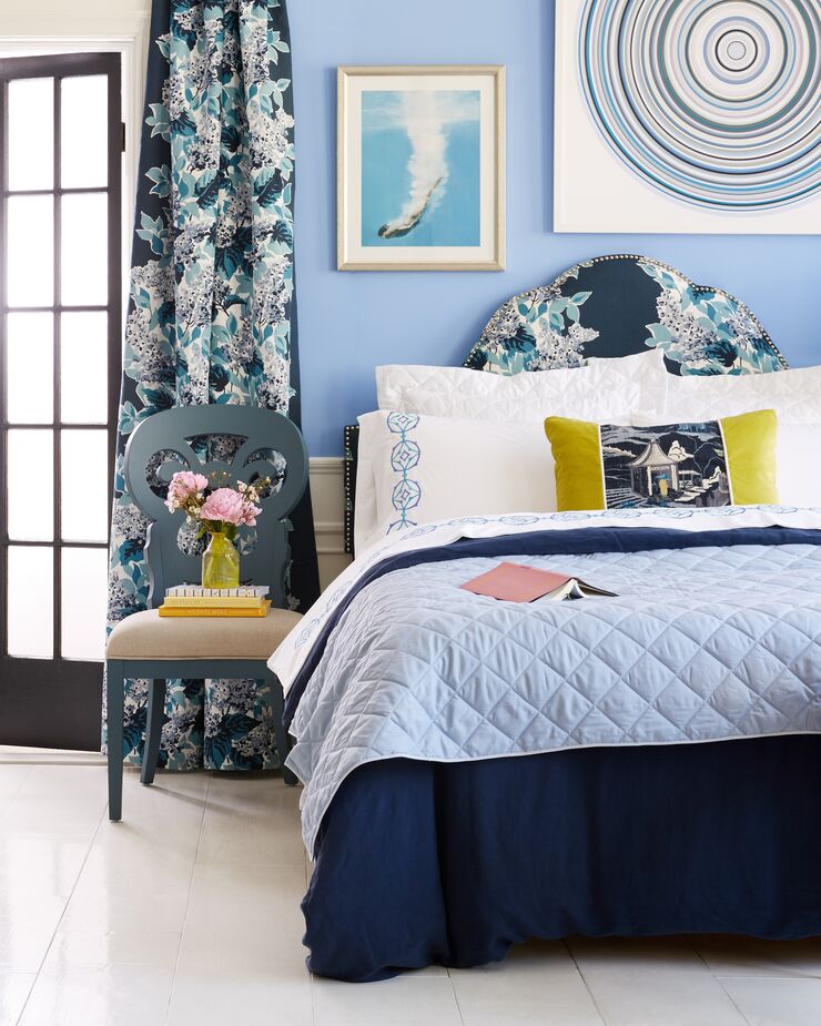 Blues in a variety of shades add layers of serenity to this bedroom.  
