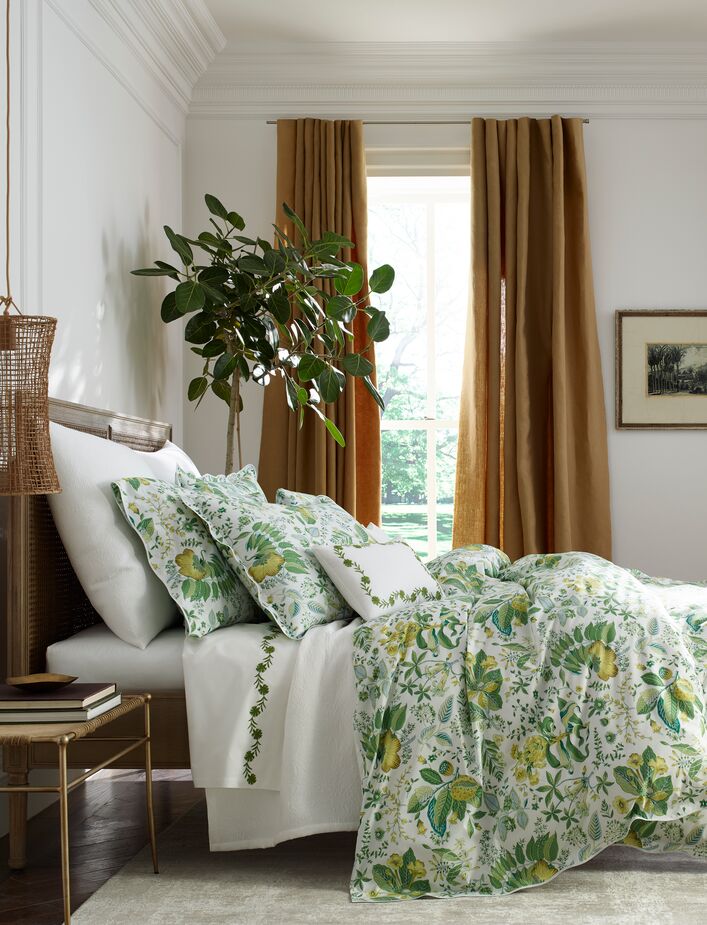 The Pomegranate Duvet Cover and Shams in Citrus nod to the other nature-inspired elements in this bedroom, such as the rattan lampshade. 

