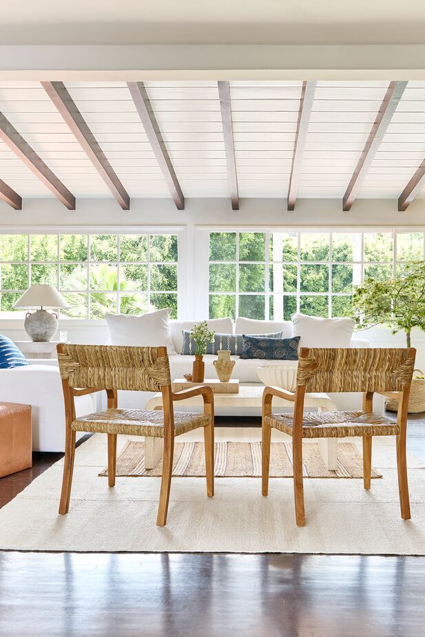 This living room is a cornucopia of textures. Shown: the Bowie Teak/Woven Rush Armchairs and the Chestnut Stripe Rug in Blue atop the Koukila Stitch Natural Rug.
