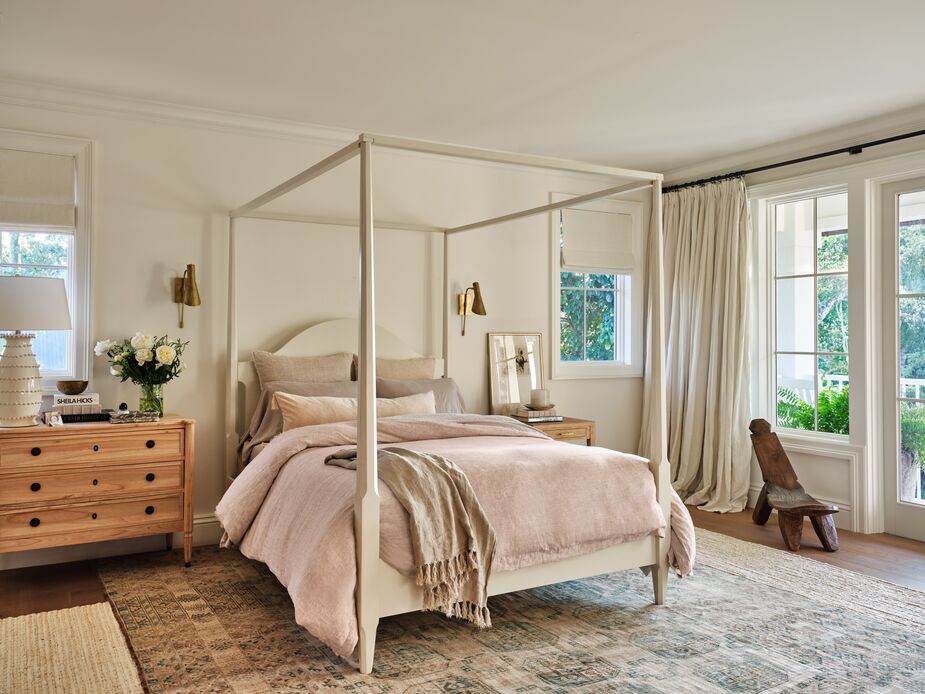 Every element in this bedroom, from the oak canopy bed to the linen sheets to the vintage Afghan rug, will stand the test of time. Find the dresser here and the sconces here. Photo by Read McKendree.
