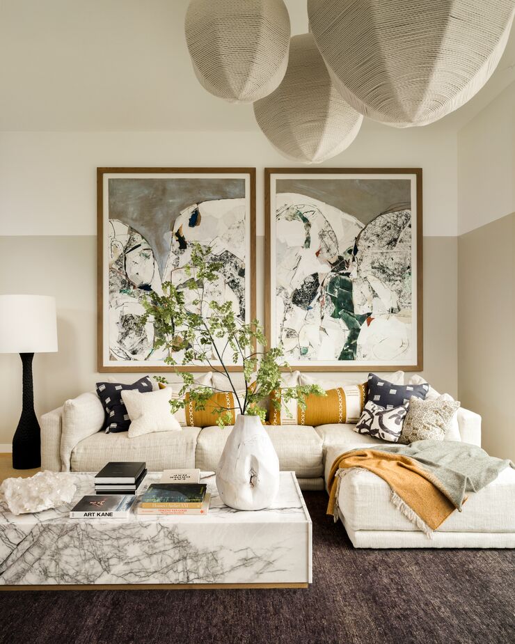 A rope light fixture by CUFF STUDIO and commissioned art by Jackie Leishman add visual interest to the living room.
