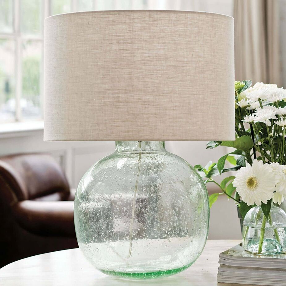 The translucent green body of the Seeded Glass Table Lamp is made of recycled glass; air bubbles provide the “seeded” texture.
