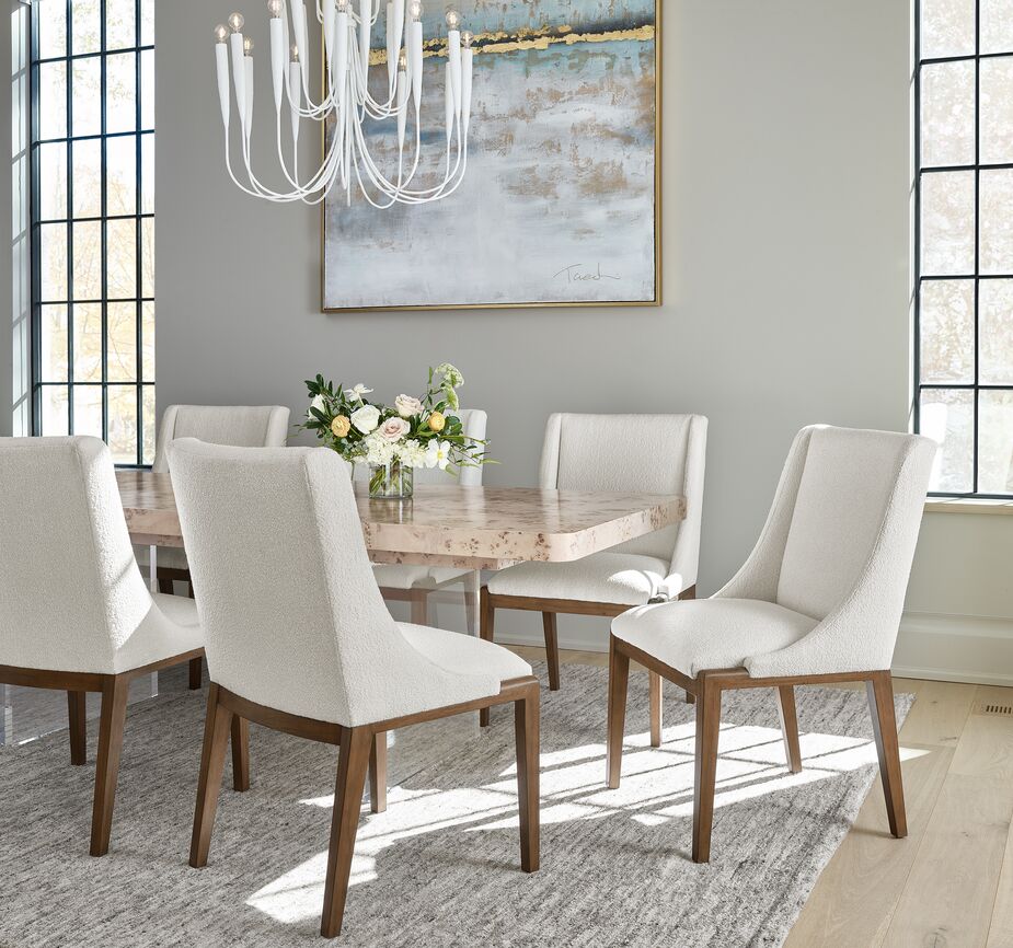 The white plasterlike finish of the chandelier (find a similar one here) complements rather than detracts from the burl top of the Tranquility Extension Dining Table. This particular type of burl, mappa, comes from European poplar trees. Find the dining chairs here.
