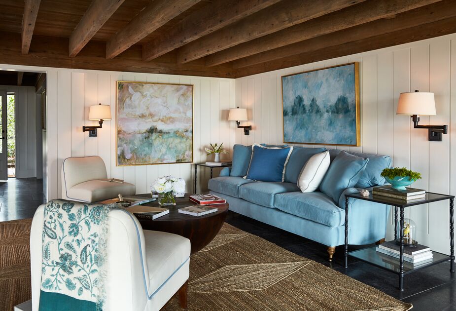 Dimmer switches are one way to vary the brightness of a room. Another is to place multiple sconces in a room. Here, you could turn on all three for maximum brightness and use just one or two otherwise. Swing-arm sconces such as those above offer even more versatility. Shown above: the Brooke 3-Seat Sofa in Light Blue Crypton Velvet, the rug Peyser Jute Rug, Coffee Fields by Laura Roebuck (left) and Cloudland, also by Laura Roebuck, above the sofa. Photo by Frank Frances.