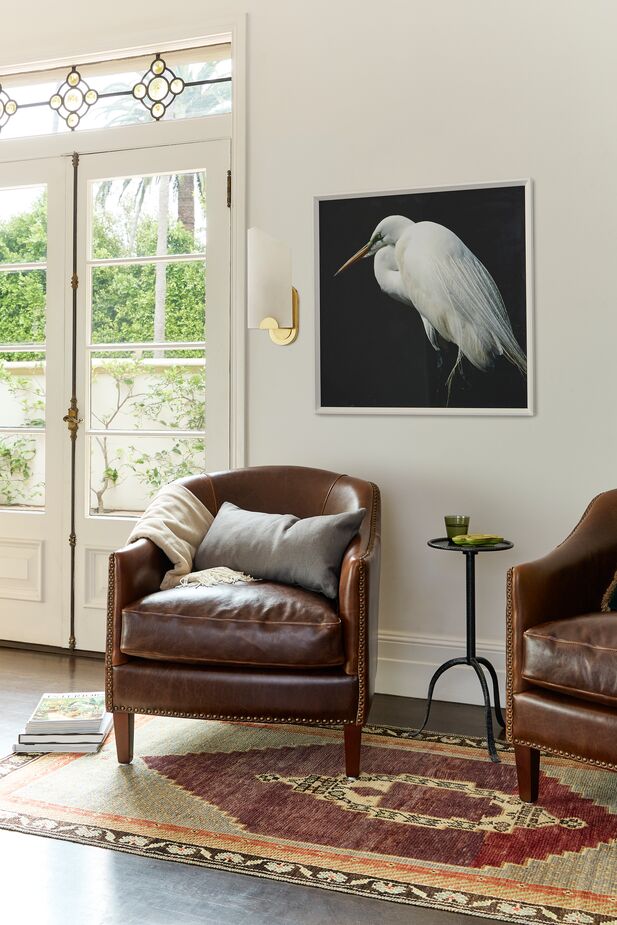 Shown above: Verona Leather Club Chair, Drinker’s Side Table, Egret Strut Framed Art. Photo by Matt Albiani. 
