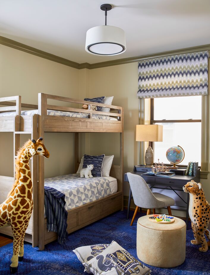 “The boy’s room showcases his current love of animals, games, and comics, but the carefully chosen colors, patterns, and textures are sophisticated enough to grow with him,” Gideon explains.
 
