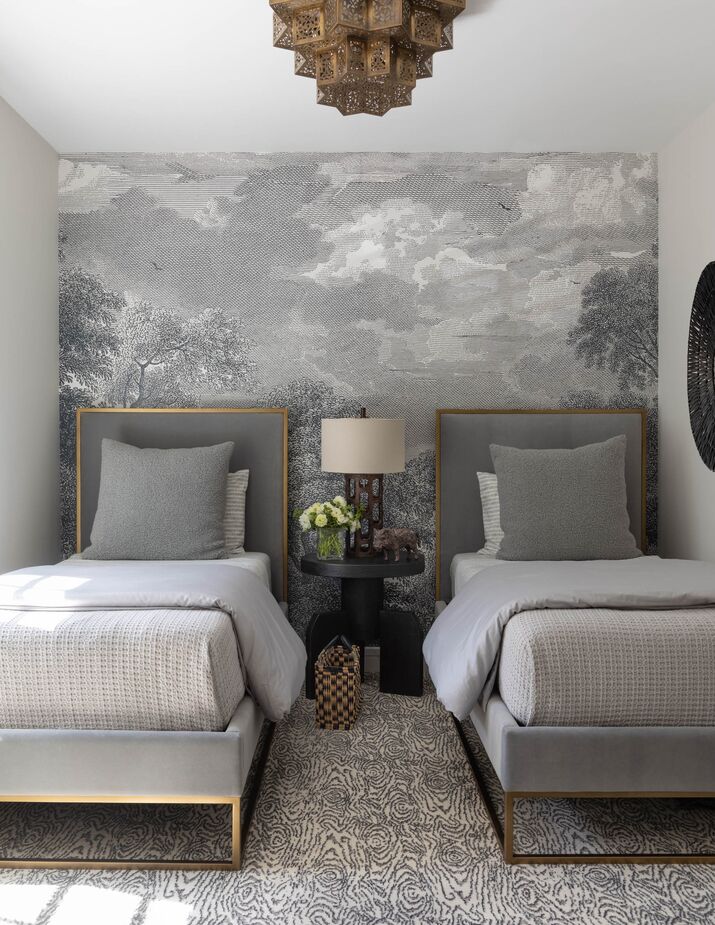 In most of the rooms, pattern is limited to the wallpaper. In this bedroom, however, the faux bois rug provides most of the pattern, complemented by a mural on one wall.
