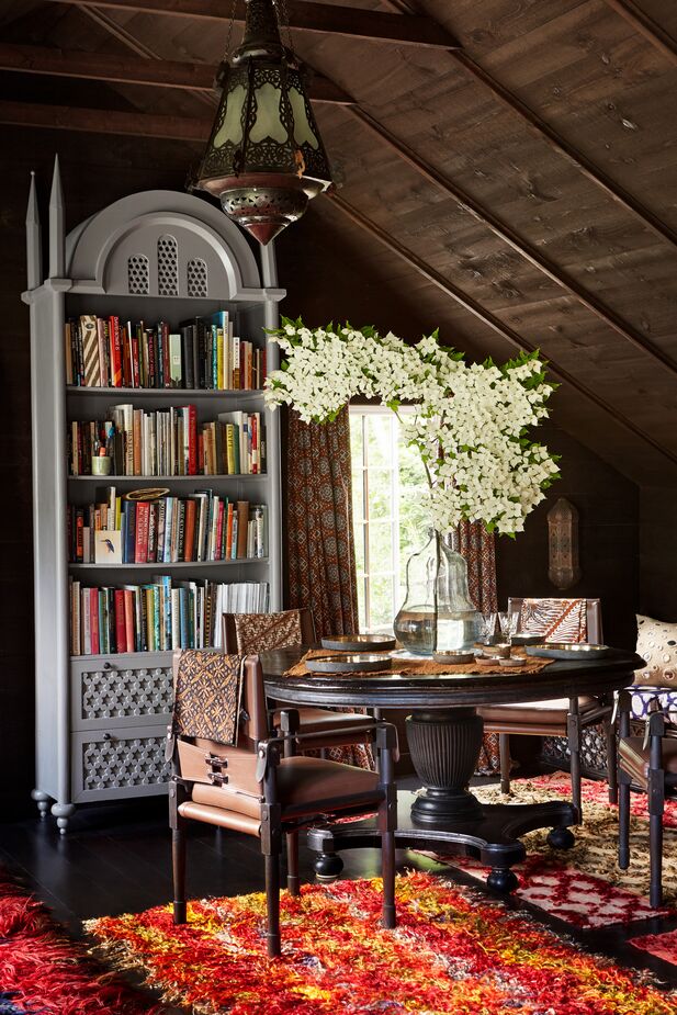 John can entertain here in his library as well as in the main house’s dining room. This teak table also serves as a desk.  
