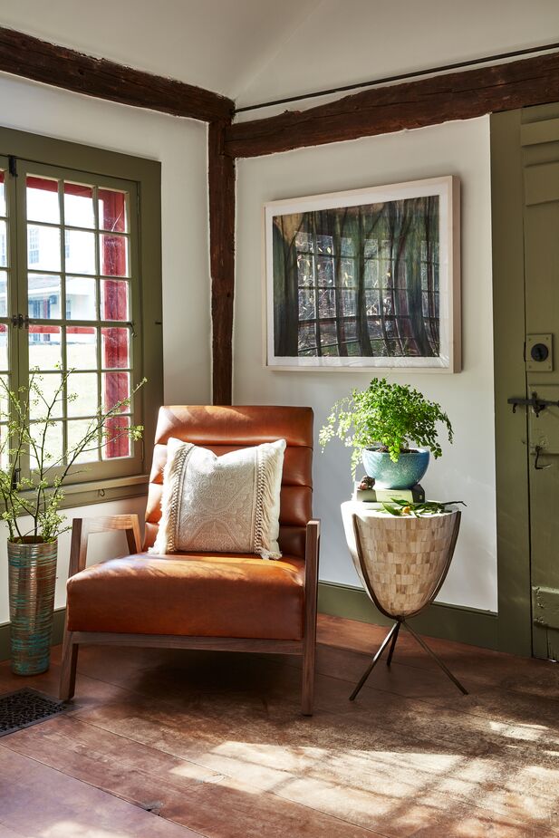 Don’t let a shortage of windows keep you from your sunroom dreams. Here, the Erik Panel Chair is positioned beside the room’s only window for soaking up the sun. Plants add to the illusion. Photo by Frank Frances.
