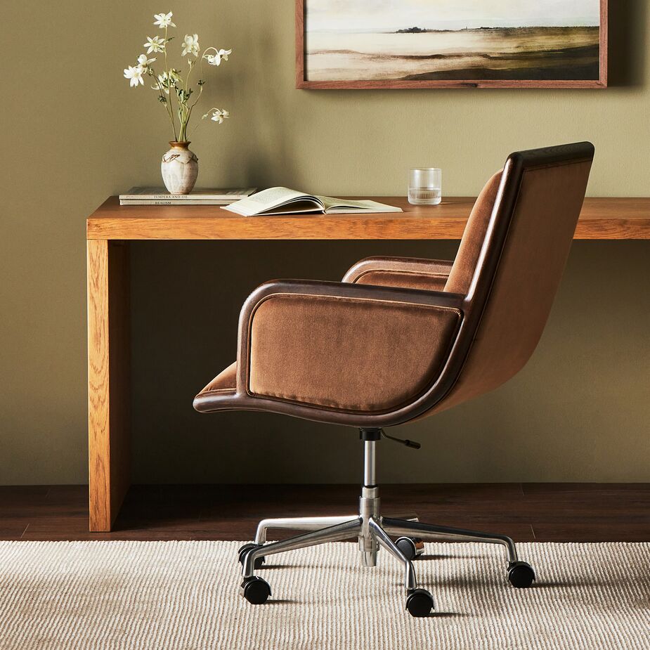 Add comfort to your command post with seating like the adjustable Nora Desk Chair, which has S-spring construction, a perfectly pitched back, and plush (yet durable) upholstery. Find a similar console table here.
