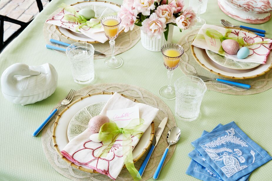 This table setting features the same place mats, dinner napkins, cocktail napkins, and cutlery as the one above, but the pale green tablecloth dresses things up a bit. Here the Classic Bamboo Dinner Plates complement the Melon Salad Plates. Feel free to mix not just patterns but also vintage finds, such as the Limoges Duck Tureen, among newer pieces. Photo by Read McKendree. 
