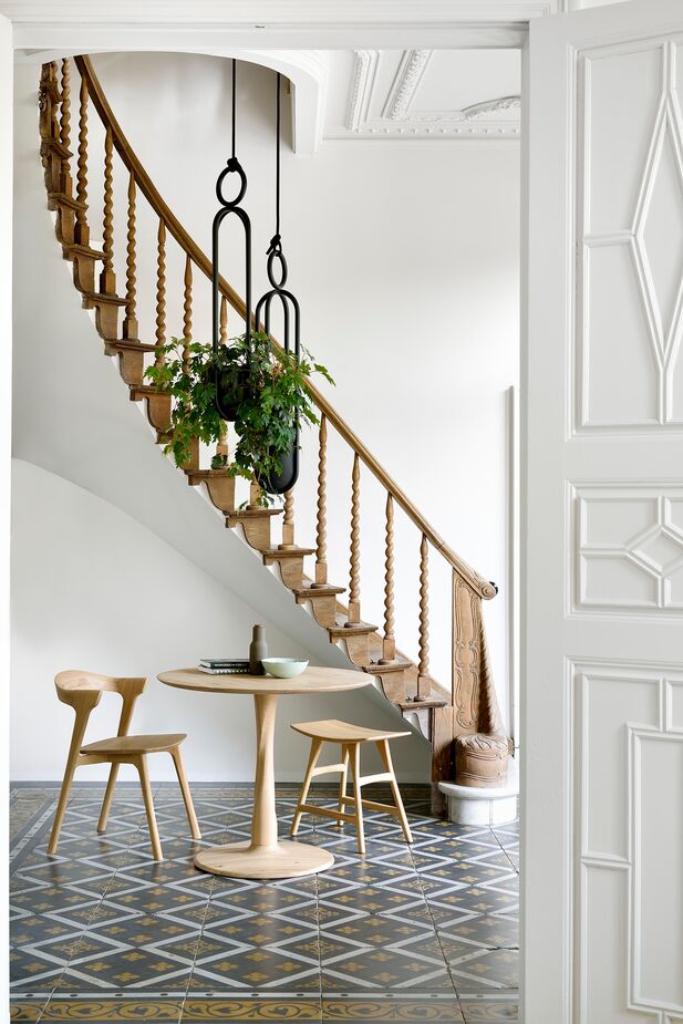 A foyer or entry hall can easily serve double duty as a dining area, especially if you already have an entry table in the space. Shown above: Torsion Dining Table in Oak, Bok Armchair in Oak, and Osso Counter Stool in Oak.
