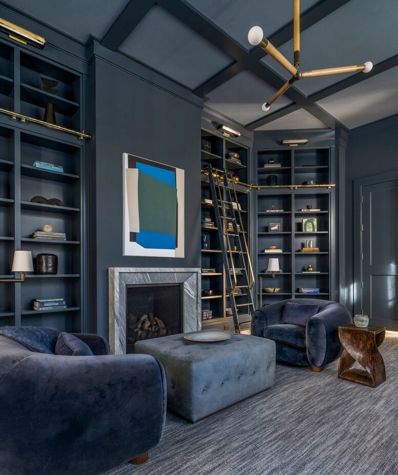 The luster of the cashmere velvet armchairs and the brass sconces and bookcase lighting accentuates the library’s luxurious ambience. 
