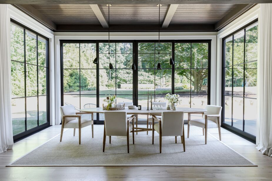“The breakfast room holds a special place in my heart,” says Becky, who opted for minimalist furnishings that wouldn’t detract from the views. Find similar dining chairs here and a similar rug here. 
