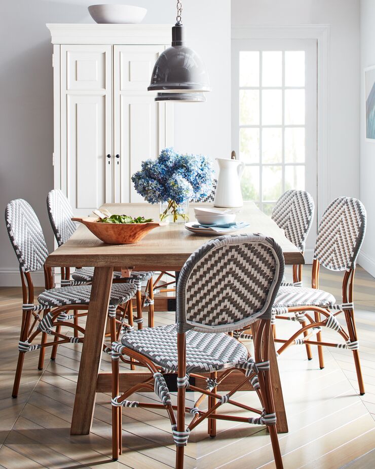 A pair of pendants (find similar here) ensures that even those at the far ends of the table aren’t left in the dark. Find a similar table here. Photo by Cheng Lin.
