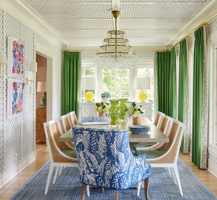Layering patterns, as she did here and throughout the home, “is part of my innate design vocabulary,” Amanda says. “I suggest choosing a large-scale, possibly multicolored ‘main event’ fabric first and then coordinating a smaller-scale print, a stripe or plaid, and a solid along with it.” Amanda added the yellow table lamps to tie in with the yellow in the curtains’ tape trim. Find a similar buffet here. 
