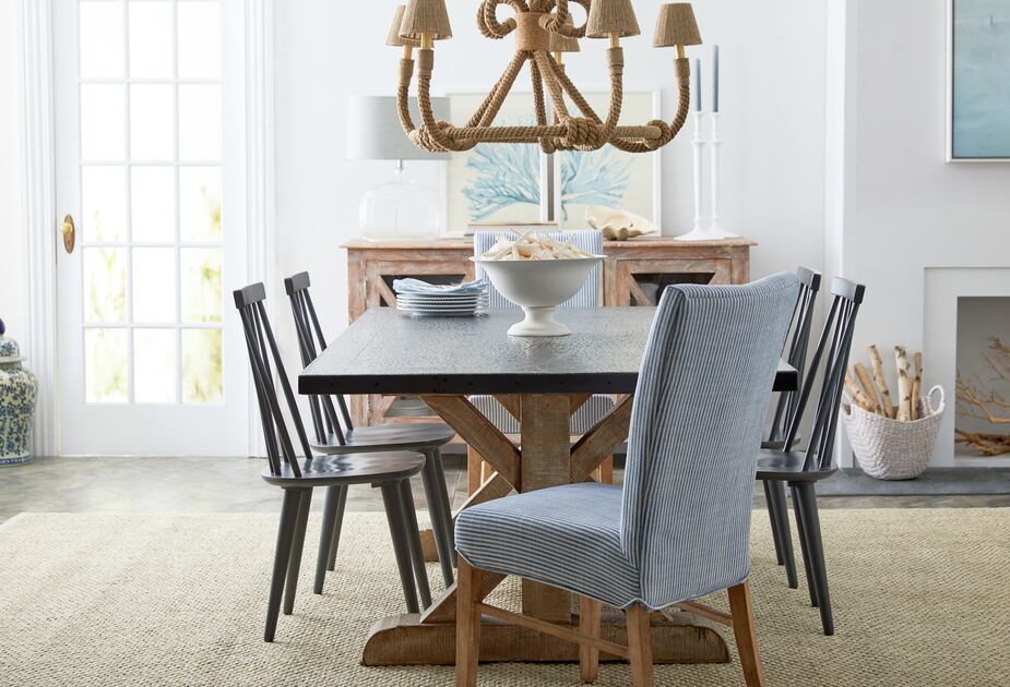 Wrapped in jute, this chandelier accentuates a coastal vibe when complementing blue-striped chairs (the Shannon side chair is similar to those above). Even without the nautical stripes, a jute lighting fixture brings organic elegance to  a space. Find the Windsor-inspired chairs here.
