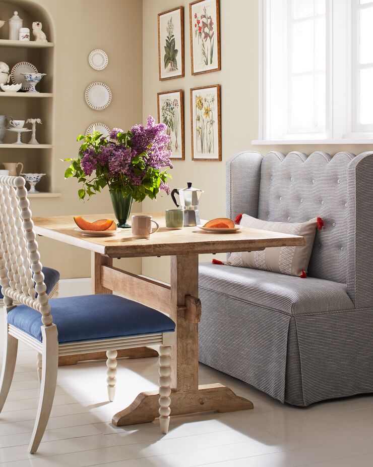 A banquette can transform even a slender space into a breakfast nook without the need for constructing a built-in. Find the chairs here.
