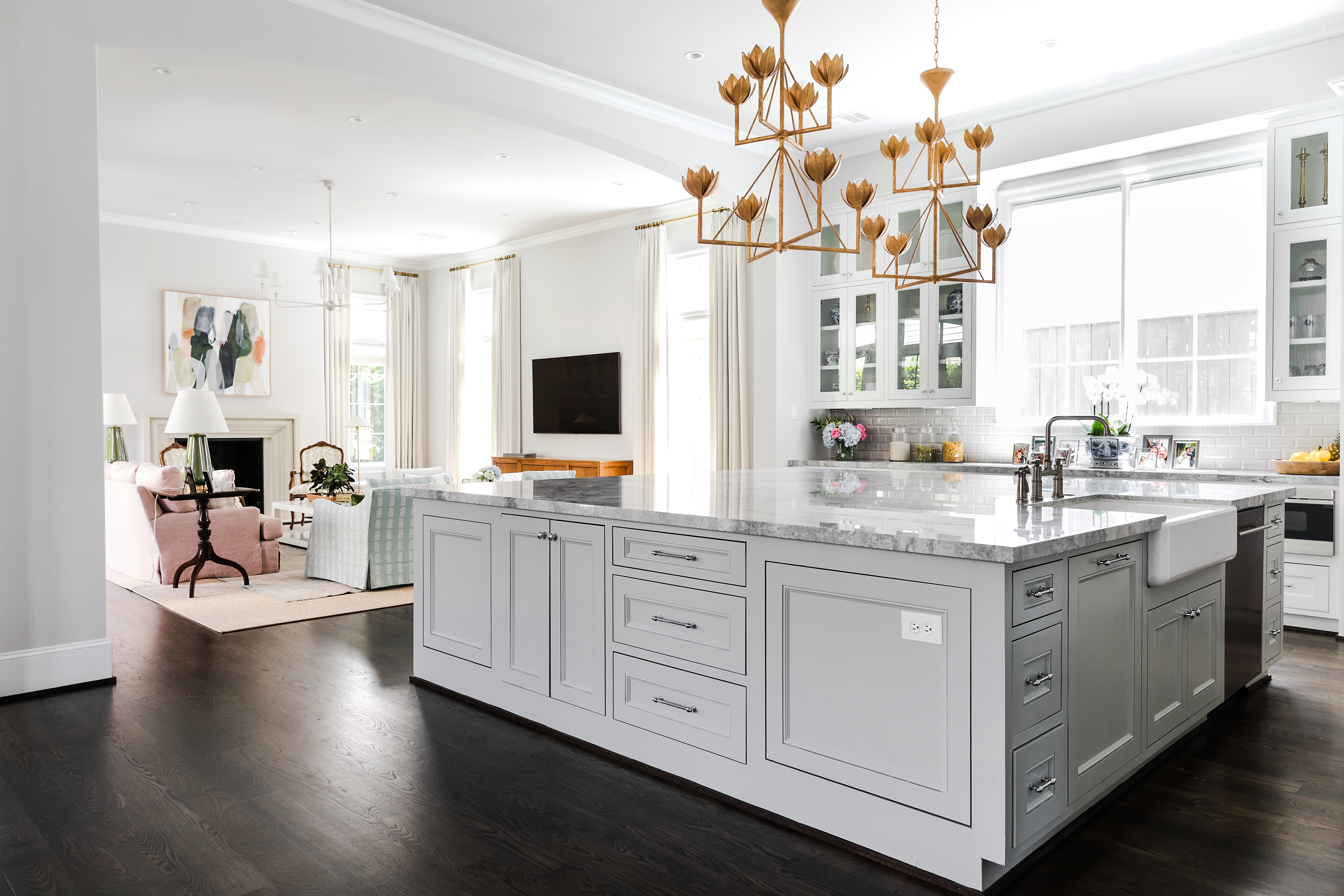 The living room flows into the kitchen, which shares the same warm, bright ambience. Find the chandeliers here.
