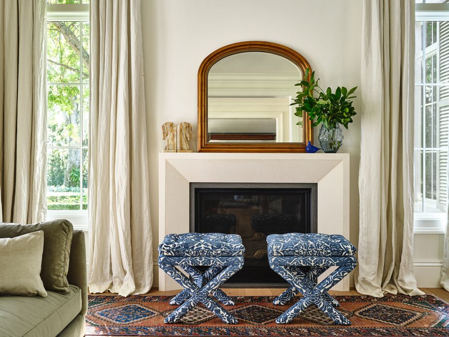 Nearly as wide as it is high with a thick golden frame, the Mason Mantel Mirror holds its own in just about any room. Here it complements a pair of Dalton Pillow-Top Ottomans in Twilight.
