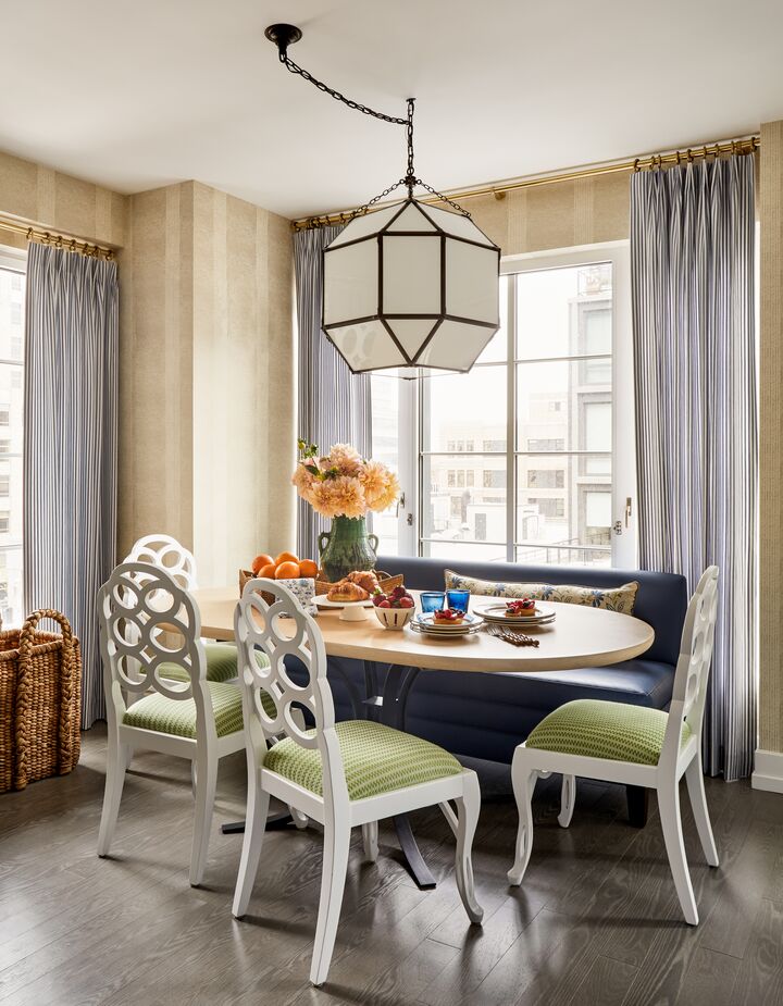 Taking into account the homeowners’ young children, Jennifer upholstered the banquette in “vegan leather”–aka high-end, easy-to-clean vinyl–and laminated the chair upholstery. “We don’t like to sacrifice style, but everything we do is very durable,” she says.
 
