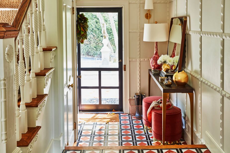 The Piper Stools (shown here in Rust) tucked beneath this console can be used here as a perch as well as carried out to the living room when you need extra seating for visitors. Find the sconce here. 
