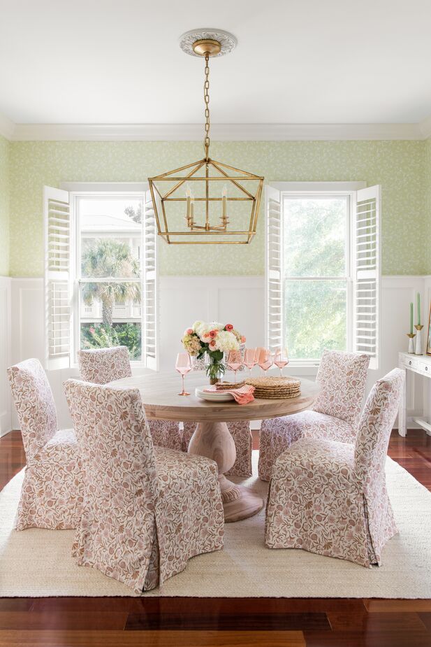 Six Owen Side Chairs (shown here in Vine Botanical Pink) fit comfortably around the 55-inch Charlotte Round Dining Table. Find the light pendant here. Room by One Kings Lane Interior Design. Photo by Katie Charlotte Lybrand.
