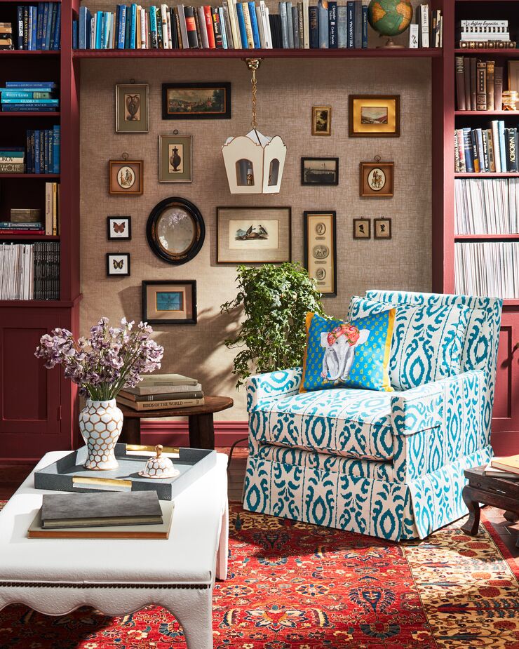 With its wall of curios, Persian rug, and layered patterns, this room captures the spirit of Victorian style. Find the pillow (in a different color) here and the ginger jar here. Photo by Cheng Lin.
