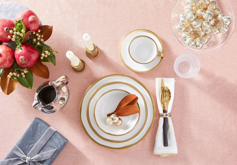 Snow-white napkins, neatly encased in Cabochon Napkin Rings, enhance the luxuriousness of the gold-edged dishware. Photo by Tony Vu.
