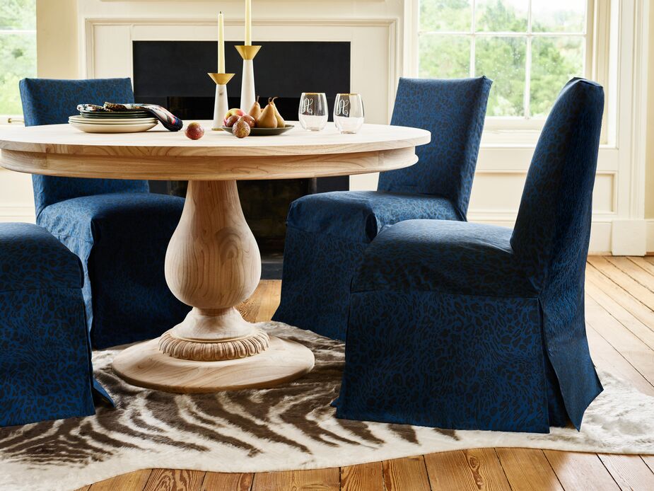 Must-haves for a cozy dinner for two include well-cushioned seating (like the Owen Side Chair, shown above in Pounce Navy) and candlelight. Find the candleholders here, the monogrammed glasses here, and the table here.
