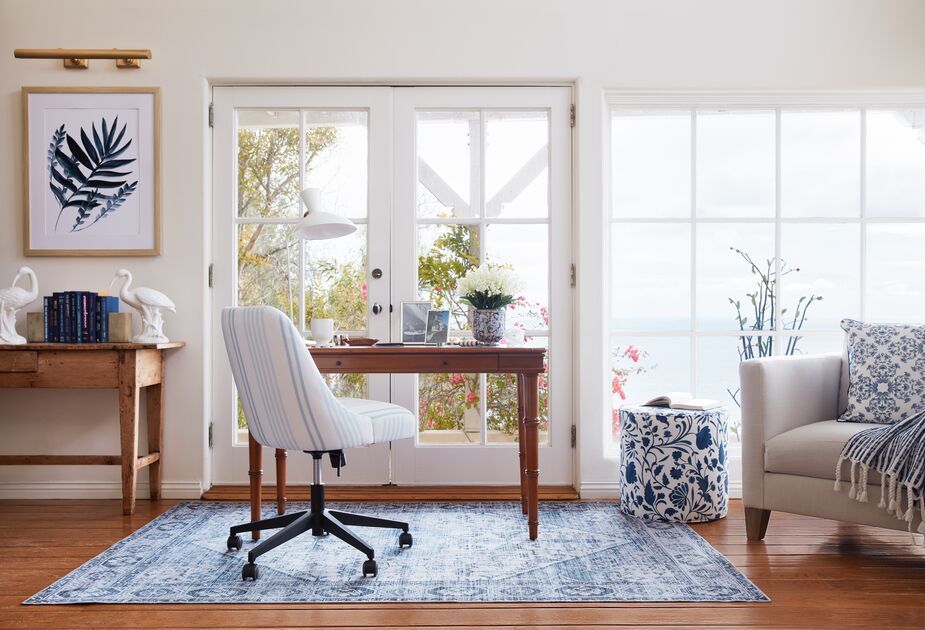 The Celeste Elsa Stripe Desk Chair lets you enjoy both comfort and style. Find the desk here and the floral ottoman here. Photo by Joe Schmelzer.
