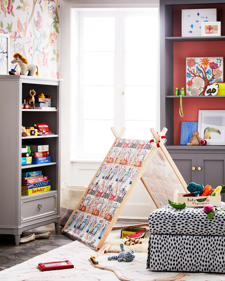 Keeping storage within kids’ reach gives them no excuse not to put away their toys and clothes. Using closed as well as open storage helps contain chaos. Find the ottoman, upholstered in stain-resistant fabric, here. Room by One Kings Lane Interior Design. 
