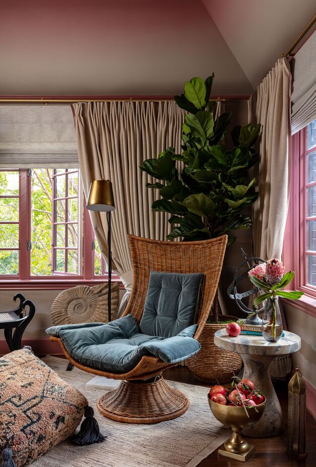 This brass-accented vignette captures the Moroccan-boho theme of the en-suite bedroom designed by Kristi Nelson of KMNelson Design. Painting the millwork pink is unconventional—but then again, so is this room in general. Find a similar side table here. 
