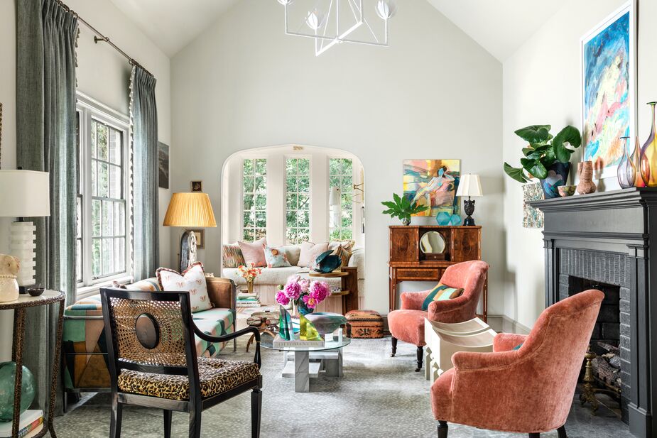 The living room is a salmagundi of heirlooms, vintage finds, and new designs, such as the Alberto Two-Tier Chandelier. Find a similar rug here.
