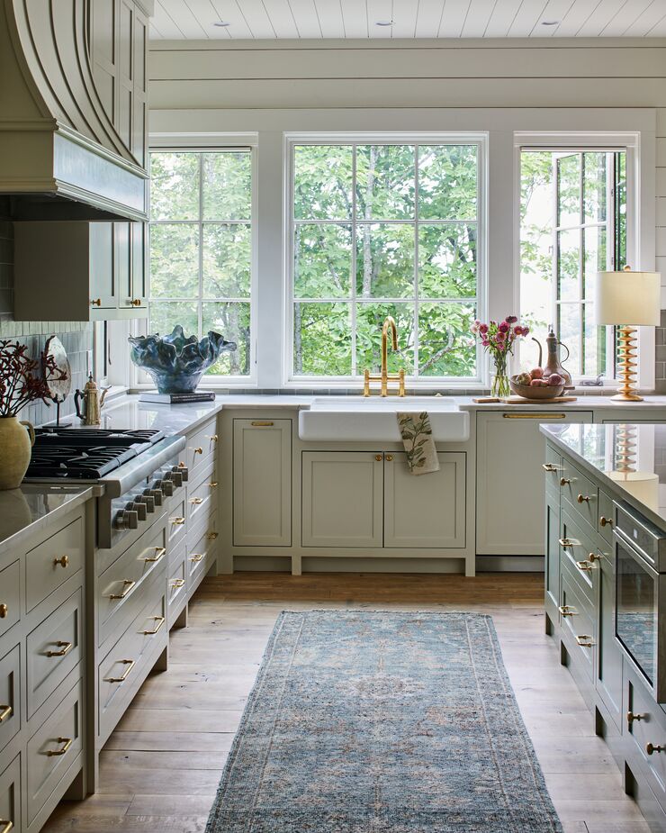 An unlacquered brass bridge faucet adds a dose of shine to an otherwise neutral kitchen.
