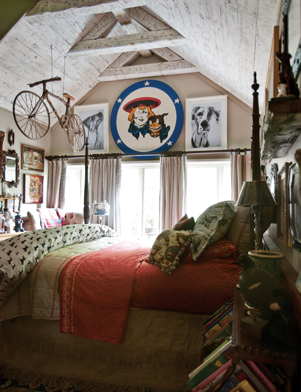With canine collectibles, art, and textiles, this guest bedroom is a dog-lover’s delight. A mini library of children’s books beside the bed and whimsical accents such as the hanging bicycle make it a haven for kids as well.

