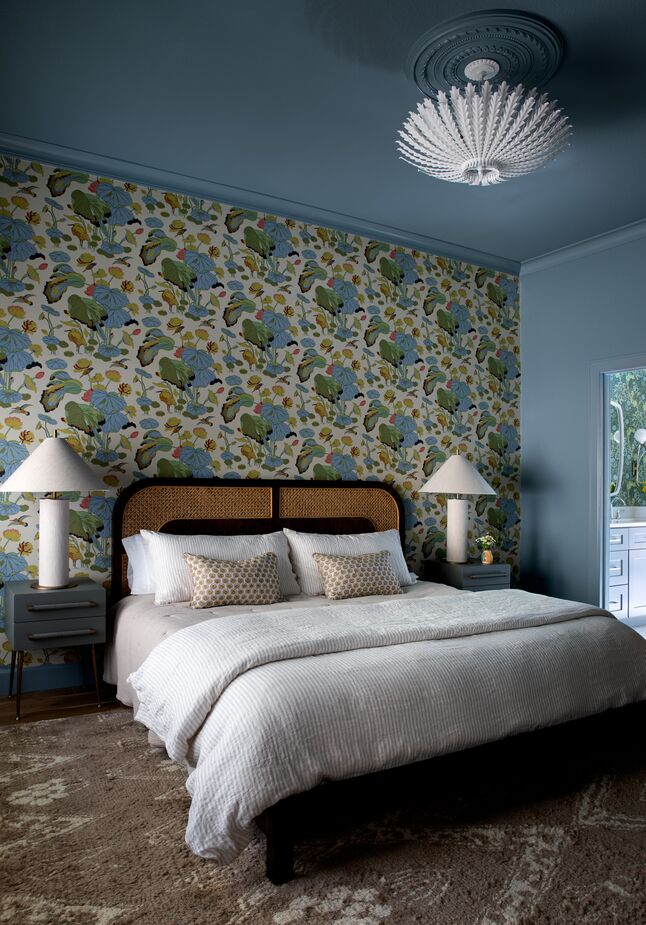 “The guest bedroom with its moody blue trim and ceiling and gorgeous wallpaper makes for such a serene and inviting space,” Shannon says. Find a similar ceiling light fixture here. 
