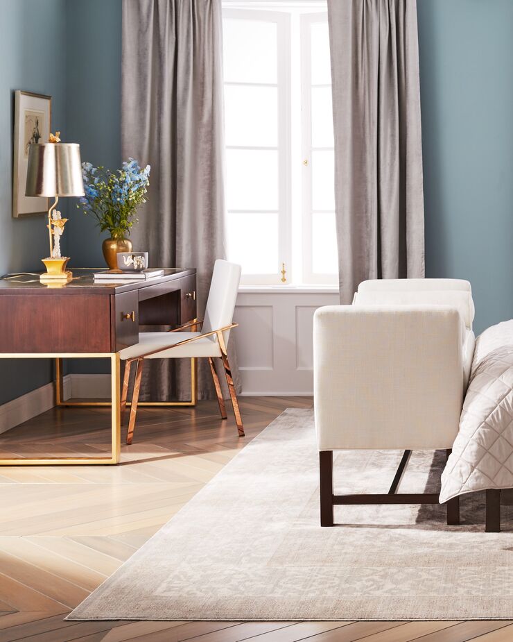 Nestled in a corner, the Melrose Writing Desk occupies a discrete (and discreet) niche in this bedroom yet is just as elegant as the other furnishings. Find a similar bench here.
