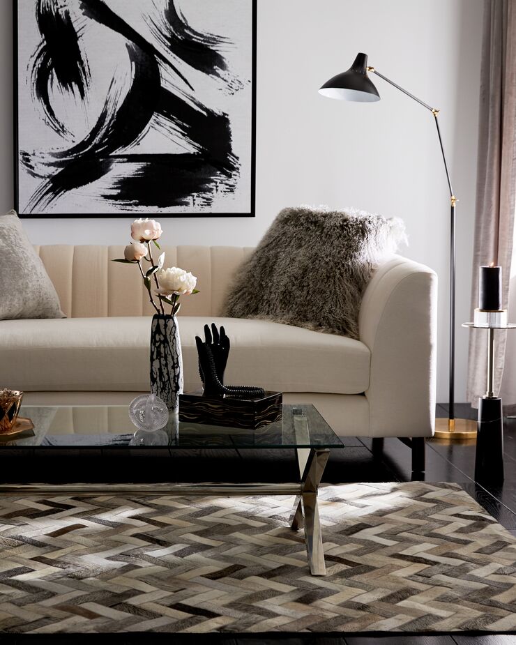 The wealth of luxe textures, from the herringbone-pattern hide rug to the linen sofa, negate the need for additional colors. Find the floor lamp here and the Tibetan wool pillow here.

