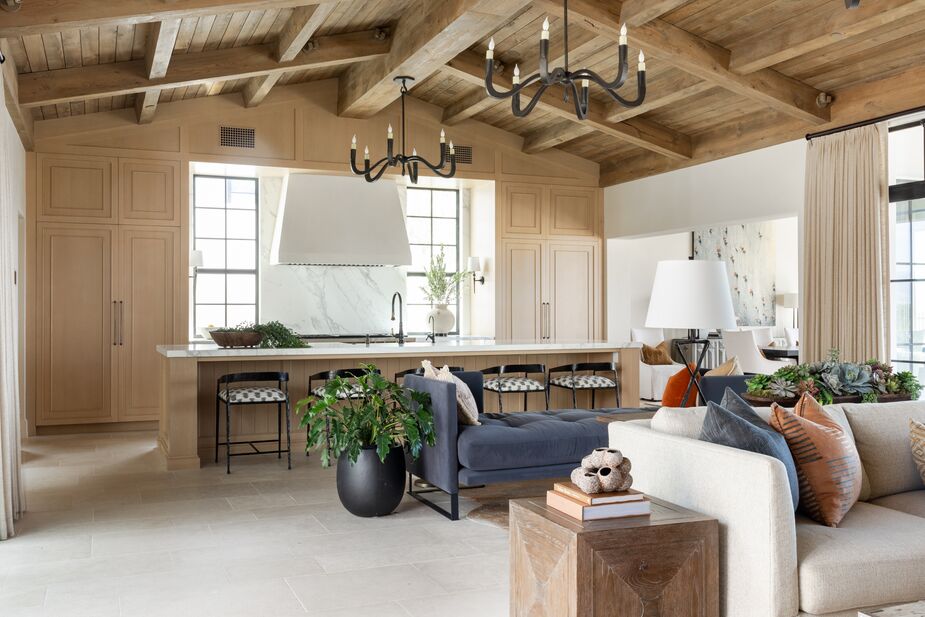 The French white oak of the kitchen cabinets was chosen, like the limestone flooring, for both its beauty and its durability. The low backs of the stools ensure a clean line of vision. 
