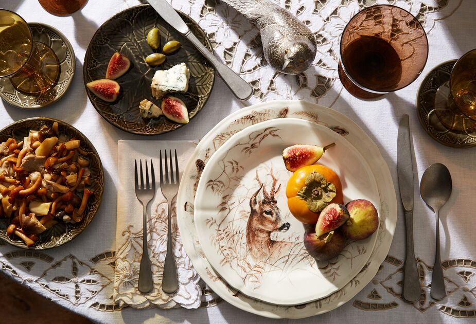 Vintage linens and tableware, including these autumnal dishes by Gien, elevate just about any meal.
