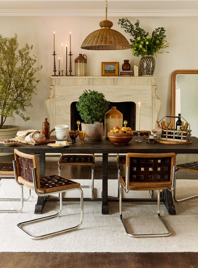 This dining room has so many textures and tones, it doesn’t register as a brown room but rather as a warm, inviting one. The nickel legs of the Revival Leather Chairs provide an ideal complement of gleam. Also shown: the Adams Dining Table and the Marled Woven Rug. Photo by Matt Albiani.
