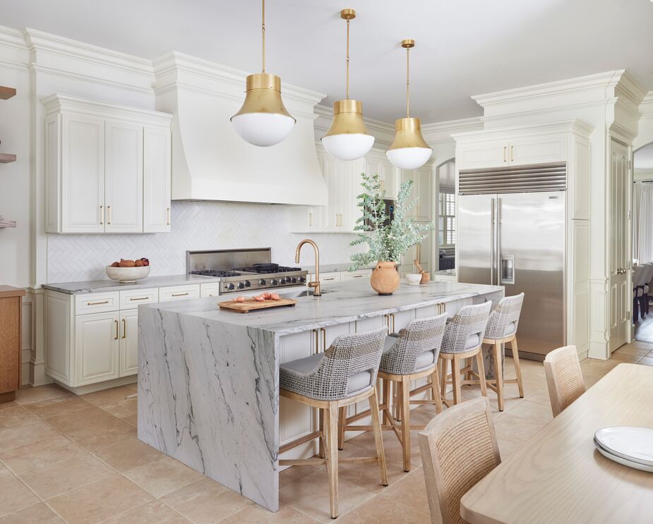 Cool neutrals create a calming space in the kitchen, while gilded accents add luxury.
