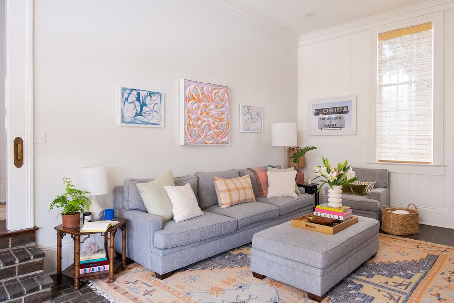 The family room’s muted palette and generous white space around the artworks keep any one piece from overwhelming the others. Find a similar clean-lined sofa, in stain-resistant upholstery, here.
