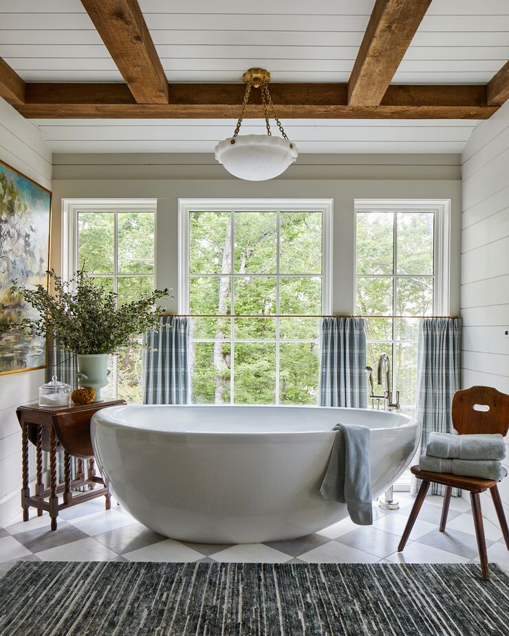 White oak, painted cabinetry with marble and checkerboard flooring add gravitas to a neutral color palette in the primary bathroom. 
